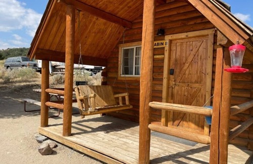 Buena Vista Cabina | 1 Room Dry Camping Cabin. Sleeps up to 4 in one queen bed and a set of twin bunks.
