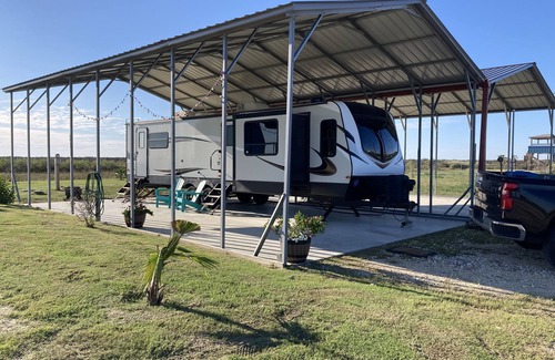 Port Bolivar Casa | 10 minutes walk to the beach .Covered rv spot on concrete slab. NEW CAMPER