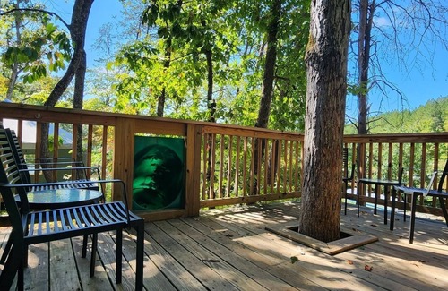 Mill Spring Cabina | 2-story treehouse with a cargo net connecting the upstairs lofts, a large balcony with a slide to the ground level, sleeps 10.