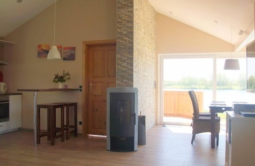 Norderteil Casa | 4 person vacation home with wood-burning stove, conservatory and canoe, with a wonderful view of the lake in Otterndorf