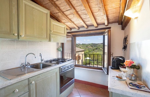 Siena Casa | Attic room with exposed beams, rustic Tuscan style