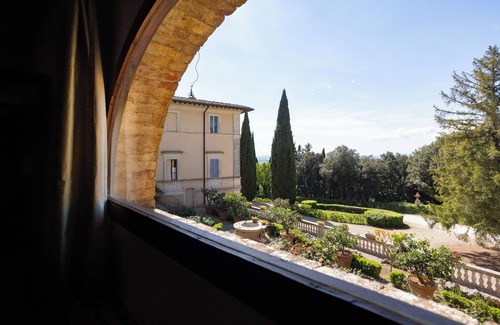 Siena Casa | Attic room with exposed beams, rustic Tuscan style