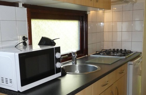 Marum Chalet De Esquí | Beautiful chalet for rent overlooking ornamental pond against forest + parking lot
