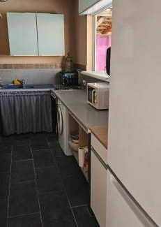 Aleria Casa | Bed and kitchen with pool