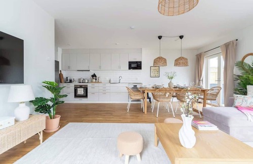 Bastad Condominio | Bright Ground Floor Corner Home with Cozy Outdoor