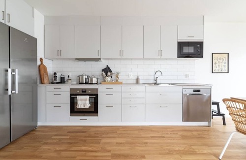 Bastad Condominio | Bright Ground Floor Corner Home with Cozy Outdoor