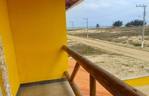 Jaguaruna Casa | Casa Pedra Ferrugem Balcony with hammock and sea view - 180m from the beach