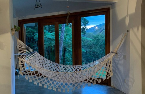 Araras Casa | Casa Tico tico das Araras surrounded by mountains in a forest reserve.