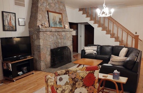 Lake Leelanau Cabaña | Classic 1920 cottage on huge lot with boat dock, fire pit patio, beautiful views