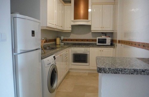 Orihuela Costa Apartamento | condominio en el acogedor jardín junto a la piscina.