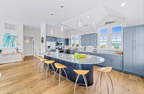 Salvo Casa | Dazzling waterfront home with balconies, private pool, hot tub, & game room