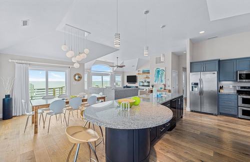 Salvo Casa | Dazzling waterfront home with balconies, private pool, hot tub, & game room
