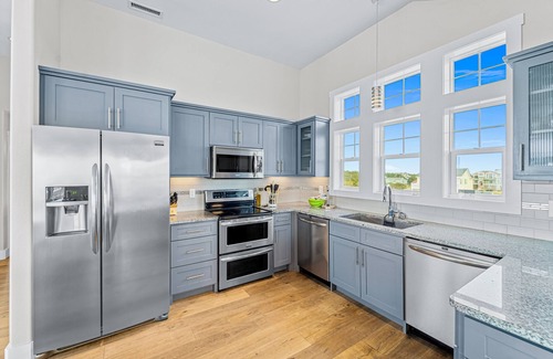 Salvo Casa | Dazzling waterfront home with balconies, private pool, hot tub, & game room