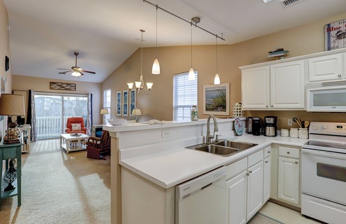 Sunset Beach Condominio | Dog-friendly condo with balcony, pool access, & W/D - near beach and golf
