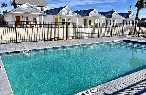 Port St. Joe Cabaña | "Dolphin Cottage" is a pet friendly, 2 bed, 1 1/2 bath unit accepting 5 guests. Community Pool.