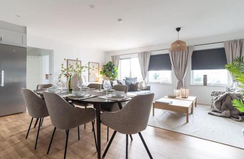 Bastad Casa | Earthy Ground Floor Home with Patio Sunbeds Greenery