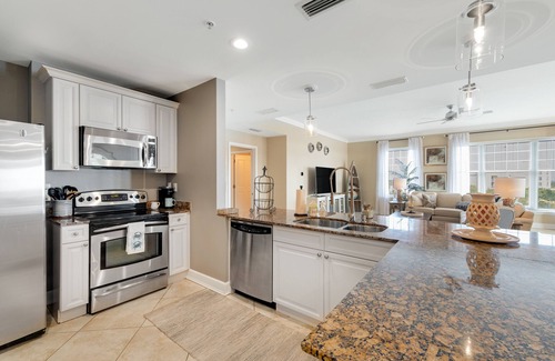 Upper Grand Lagoon Condominio | Elegant Fourth Floor Condo with Shared Pool & Hot Tub, Ocean View, and WiFi