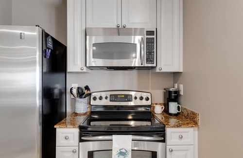 Upper Grand Lagoon Condominio | Elegant Fourth Floor Condo with Shared Pool & Hot Tub, Ocean View, and WiFi