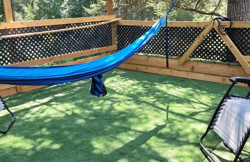 Armstrong Casa | Glamping in the woods with this Treehouse built in between 2 big alive Fir Tree