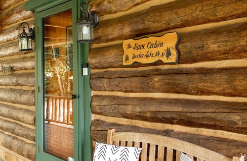 Farmington Casa | GORGEOUS log home with hot tub and private beach on peaceful Baxter Lake in NH