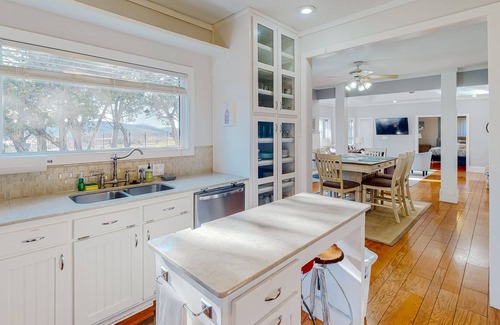 Holiday Island Casa | Gorgeous water view home with a fireplace, outdoor space & central AC