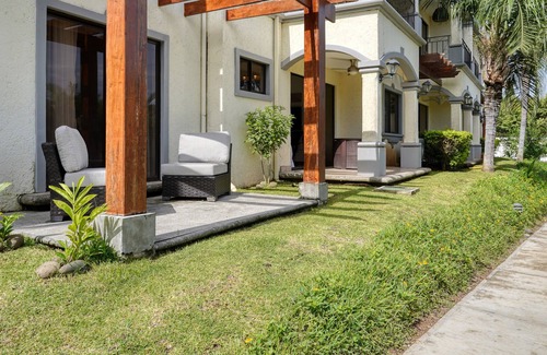 Villarreal Condominio | Ground-floor condo with pool & garden views, terrace, hot tub, AC, & W/D