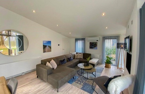 Wemeldinge Casa | Home with modern interior with air conditioning and view of the forest.