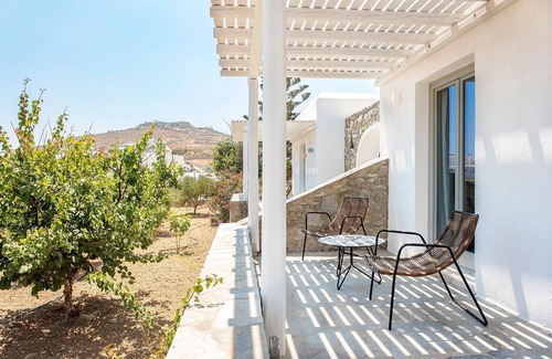 Ornos Villa | Incredible Mykonos Apartment | Apartment Revchi | 2 Bedrooms | Family Garden View Suite | Spacious Shared Swimming Pool Surrounded with Furnished Sun Terrace | Korfos, Ornos