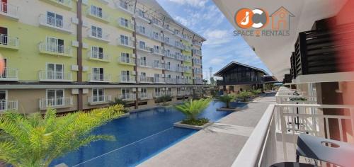 Mactan Export Processing Zone Apartamento | JC SpaceRentals 127B Amani Grand Resort Residences, balcony pool view, Ground floor, 5 mins frm airport, free wifi, Netflix