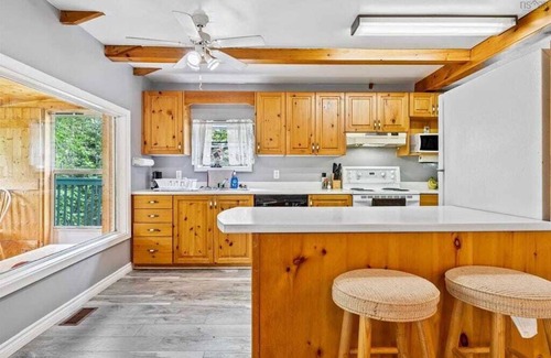 Aldersville Cabaña | June's Haven" is a picturesque lakeside cottage perfect for fishing