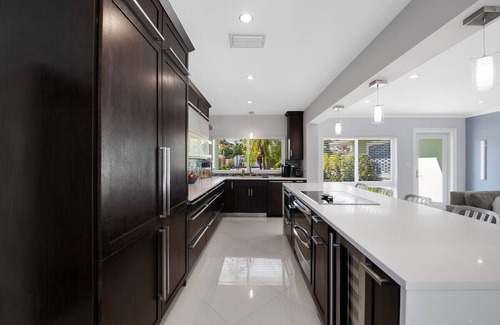 Central Fort Lauderdale Casa | Just 10min to downtown Ft. Lauderdale & beach, this modern home offers everything a group could want for an upscale relaxing getaway. Unwind in the very private and peaceful backyard oasis, featuring a heated ($) pool, 6-person hot tub & fire pit.