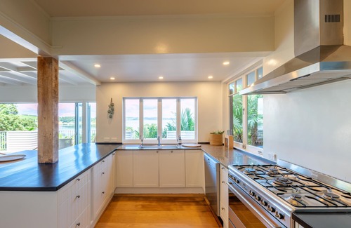 Omiha Casa | Koi Waiheke - Koi Waiheke is a stunning luxury holiday home in Omiha, Waiheke Island. With 4 bedrooms; 4 bathrooms; a large entertainer’s kitchen; spectacular ocean views; a private mooring; and a boat shed offering direct access to the ocean. This i
