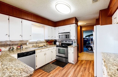 Kemp Casa | Lakefront retreat near golf course with serene wraparound deck, fireplace, & AC
