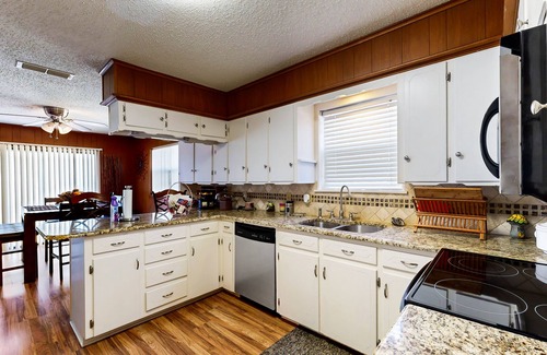 Kemp Casa | Lakefront retreat near golf course with serene wraparound deck, fireplace, & AC