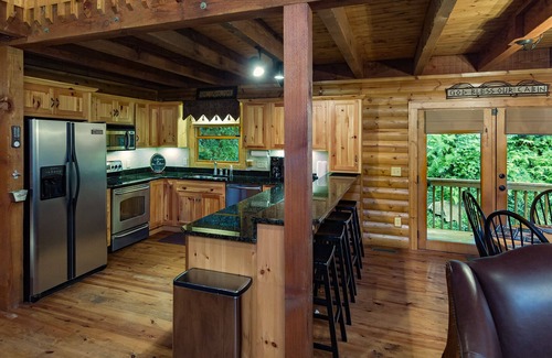 Sylva Cabina | Log cabin with large decks on the Bank of the Tuckasegee River.