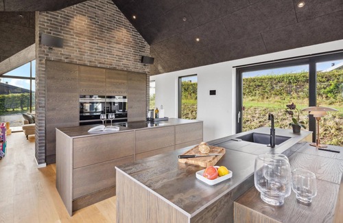 Hejlsminde Strand Casa | Look forward to a beautiful sea view in this attractive vacation home with outdoor wellness.
