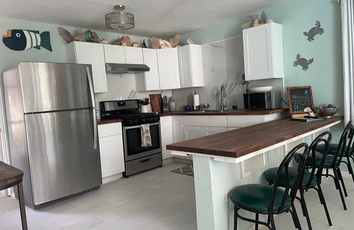 Bajo Casa | Malecon Beach House with beautiful backyard. Steps from the Caribbean ocean.