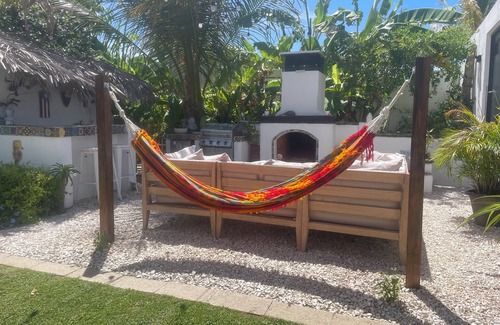 Bajo Casa | Malecon Beach House with beautiful backyard. Steps from the Caribbean ocean.
