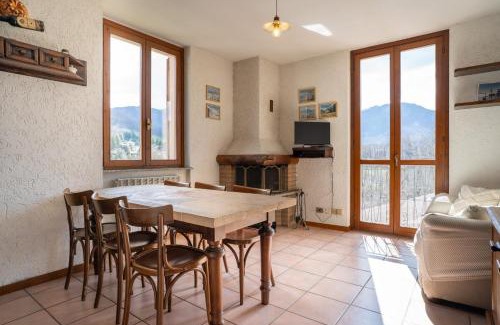 Barzio Apartamento | Mountain lodging with fireplace and mountain view