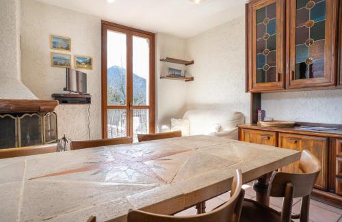 Barzio Apartamento | Mountain lodging with fireplace and mountain view