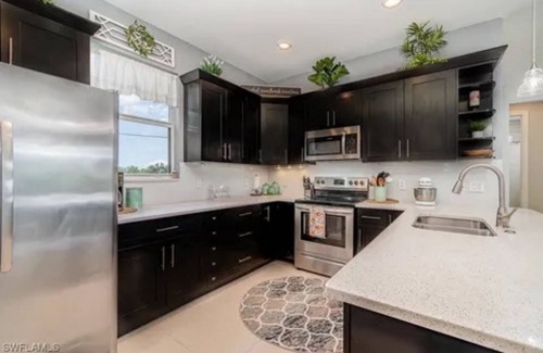 Trafalgar Casa | Paradise of Cape Coral on Canal, with Heated Pool, Tiki Hut Grill & Elec Bikes