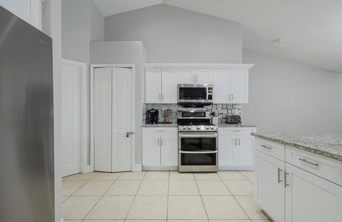 Trafalgar Villa | Pet friendly spacious home for large groups! Heated pool & jacuzzi, games!
