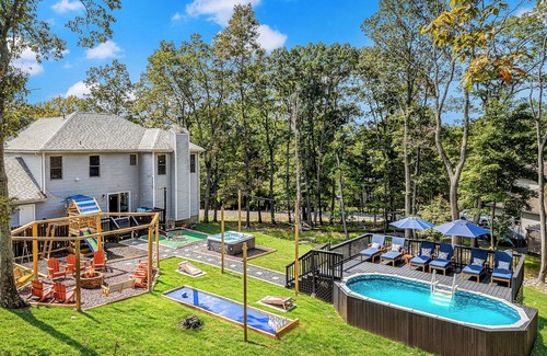 East Stroudsburg Casa | Pocono Dream House! Heated Pool, Fire Pit, Bowling, Mini Golf!