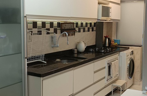 Itapema Apartamento | Private room with air conditioning, TV, minibar. In a beautiful apartment, 250m from the beach. shared