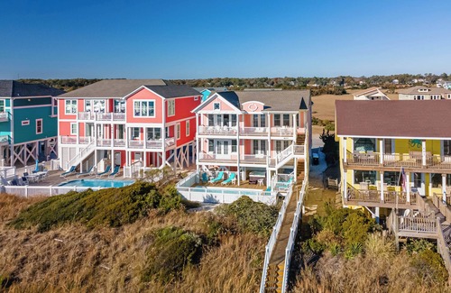 Holden Beach Casa | "Salty Pink Flamingo" is a stunning 6-bedroom, 4-bathroom oceanfront retreat with a private pool, hot tub, and elevator.