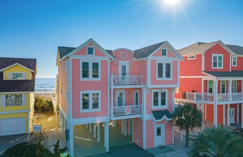 Holden Beach Casa | "Salty Pink Flamingo" is a stunning 6-bedroom, 4-bathroom oceanfront retreat with a private pool, hot tub, and elevator.