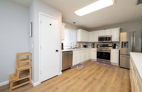 Denton Casa | Backyard with hammock, fire pit, grill, dining table, and plenty of seating!