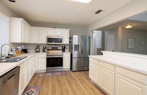 Denton Casa | Backyard with hammock, fire pit, grill, dining table, and plenty of seating!
