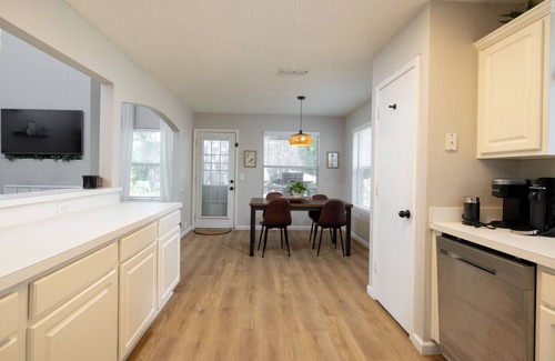 Denton Casa | Backyard with hammock, fire pit, grill, dining table, and plenty of seating!