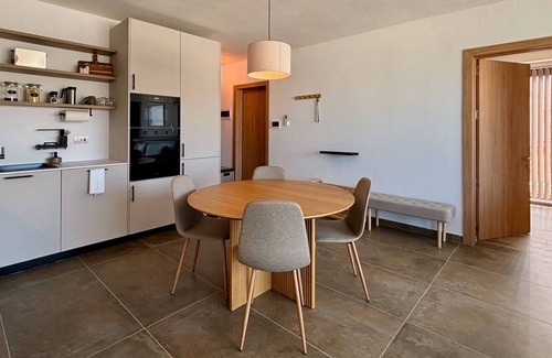 Mellieħa Heights Apartamento | Step inside to discover a modern and elegantly decorated space, featuring two spacious bedrooms with ample storage, ensuring a restful and convenient stay. The open-plan living area boasts contemporary furnishings, providing a chic and cozy atmospher
